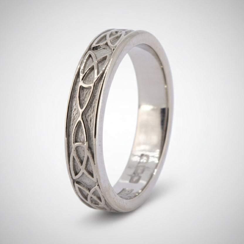 An 18ct white gold ring with a Celtic knot design, showing a textured surface.