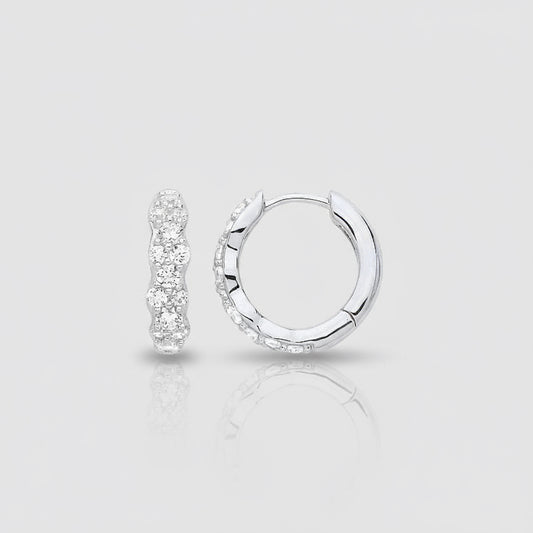 Silver hoop earrings with clear gemstones on a white background