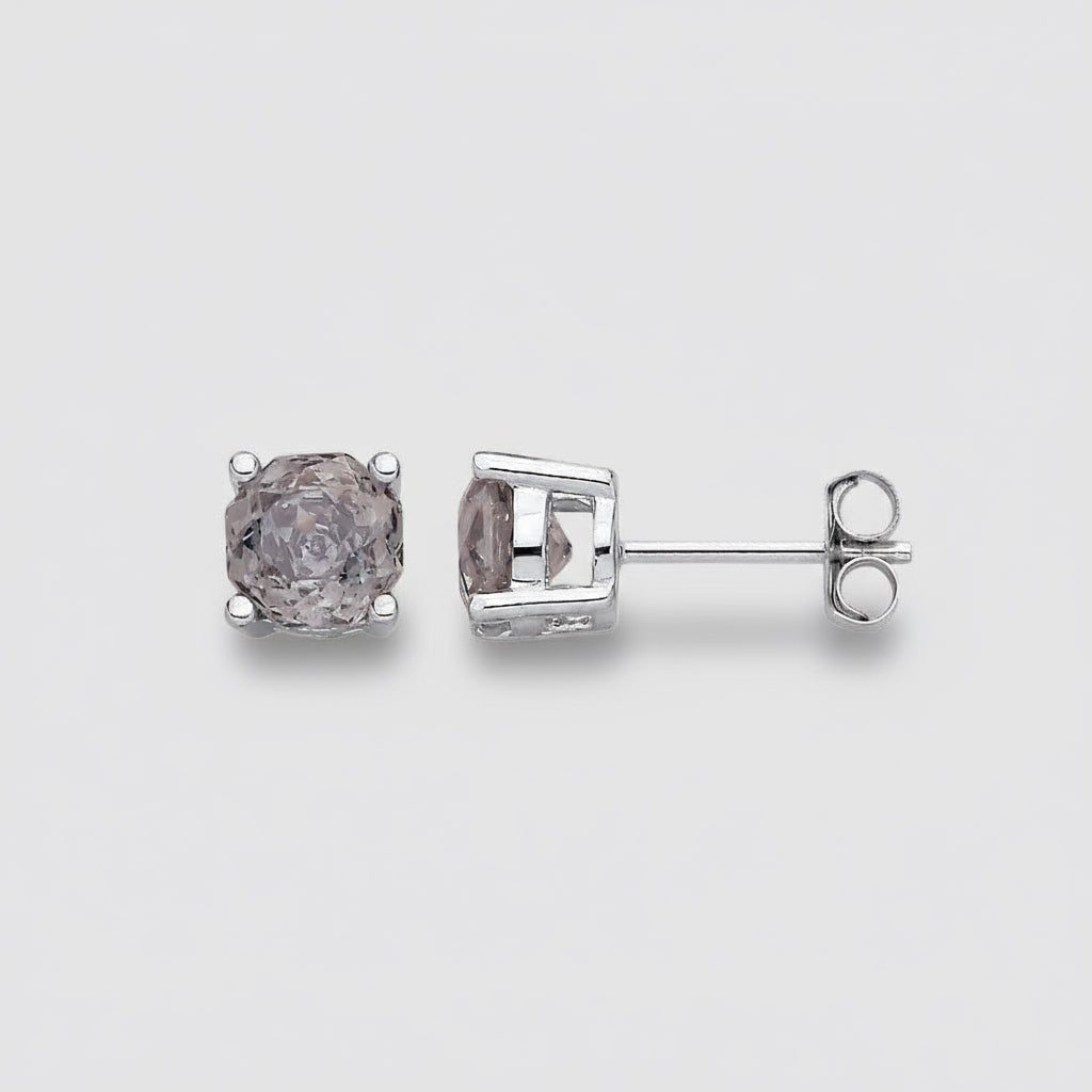 Pair of diamond stud earrings on a light gray background