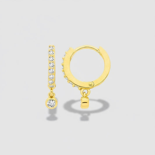 Gold hoop earrings with small round and diamond-studded details on a white background