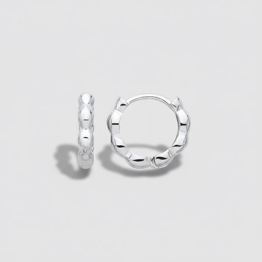 Silver hoop earrings on a light gray background