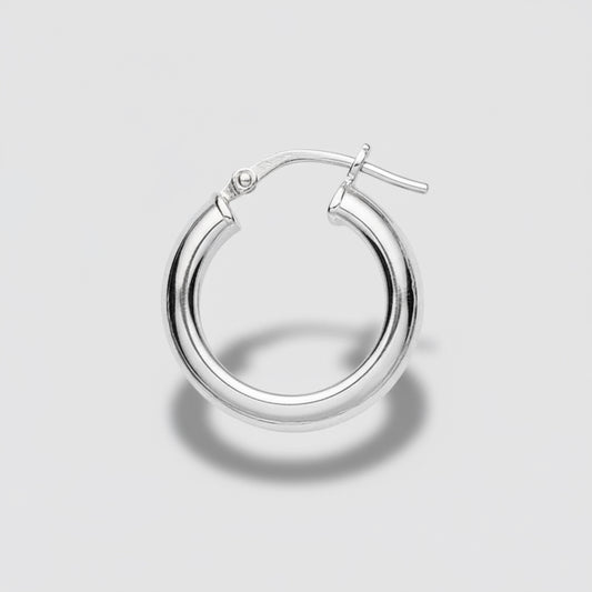 Gold hoop earring on a light gray background