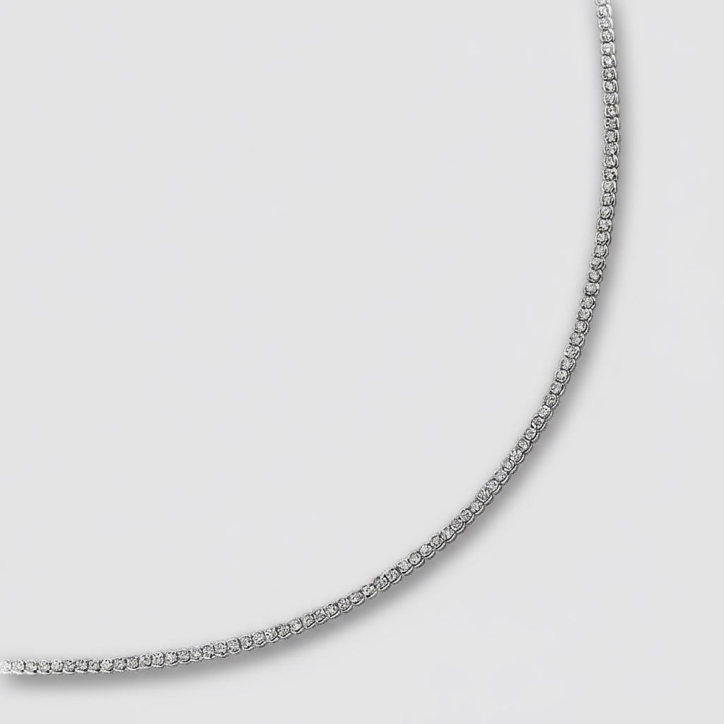 Silver chain necklace on a light gray background
