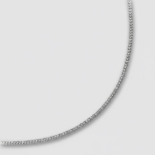 Silver chain necklace on a light gray background