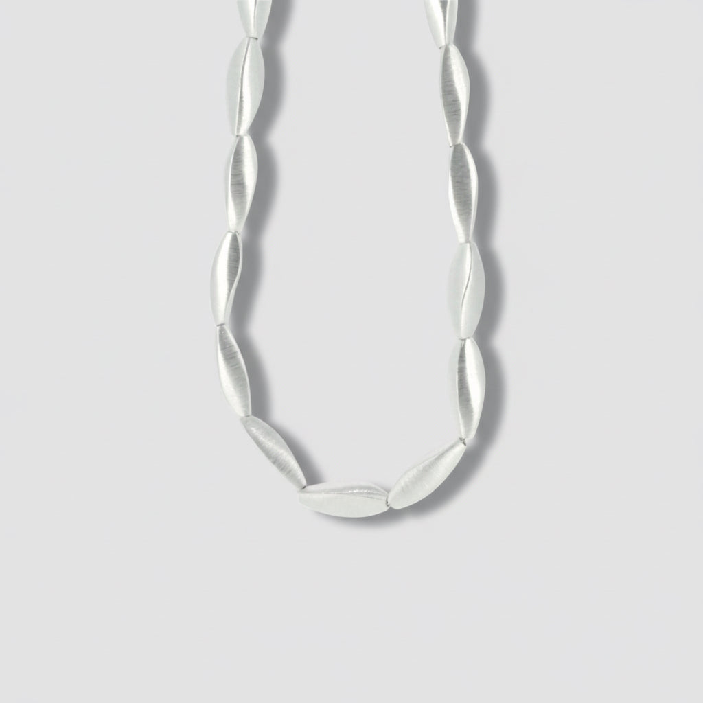 A sterling silver beaded necklace with a smooth finish.