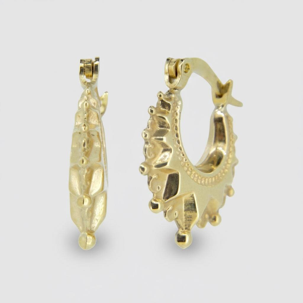 A pair of 9ct yellow gold hoop earrings with intricate designs and small embellishments.