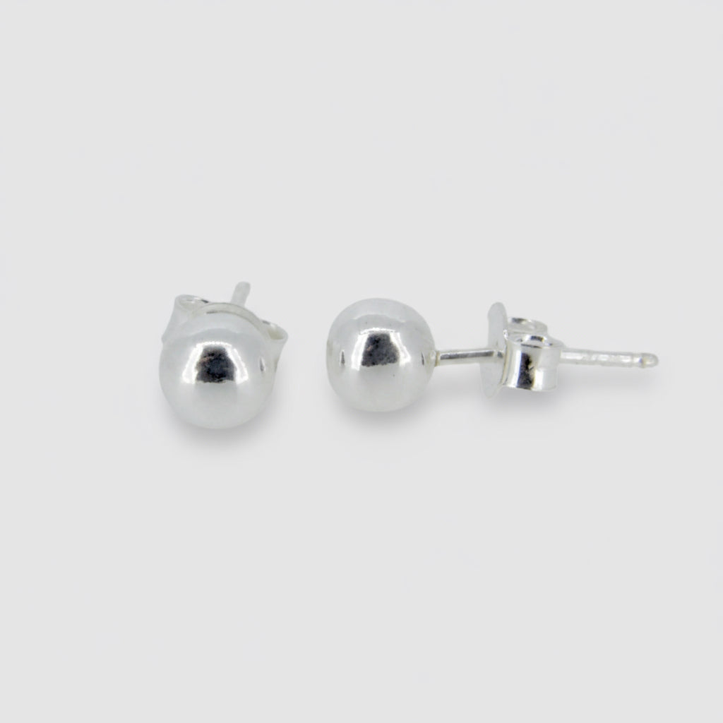 A pair of silver bead stud earrings with a rhodium plating.