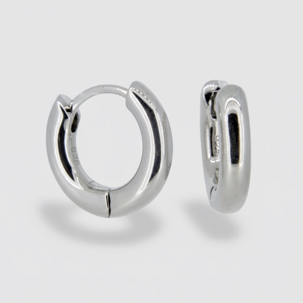 A pair of silver hoop earrings with a rhodium plating.