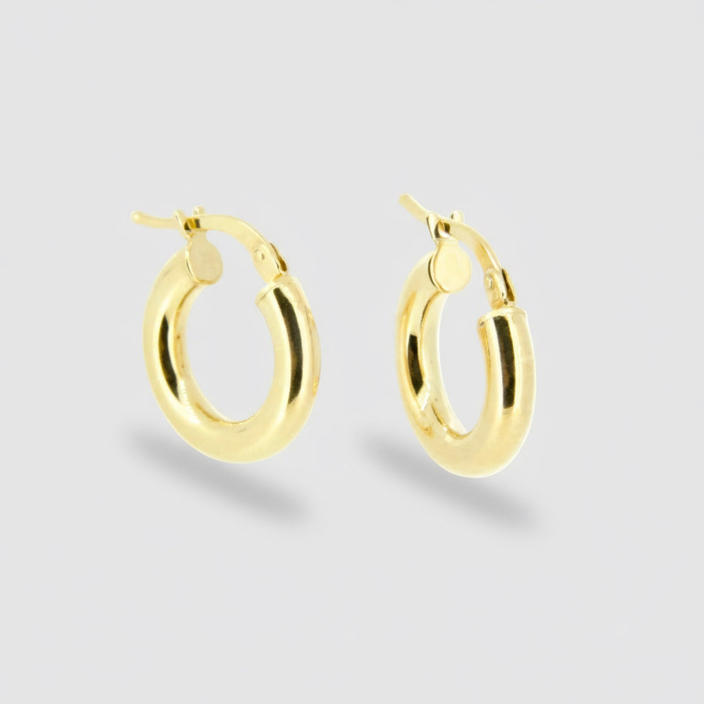 Gold hoop earrings on a white background
