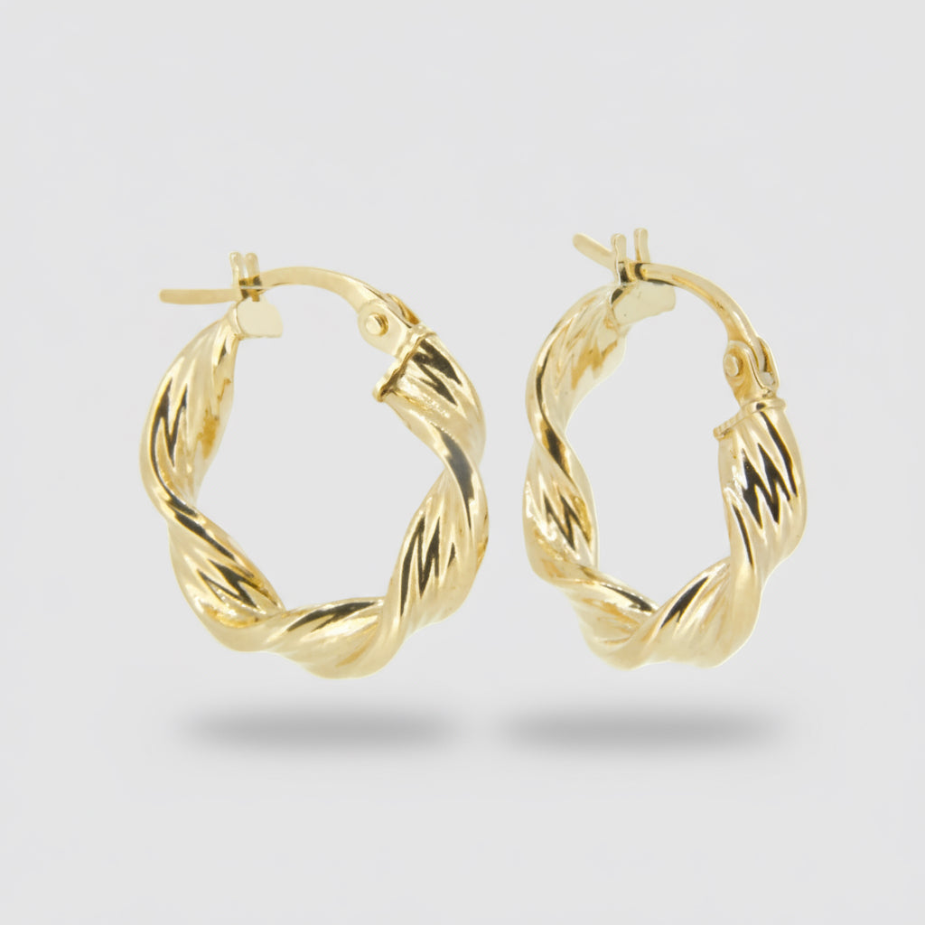 Gold hoop earrings on a light gray background