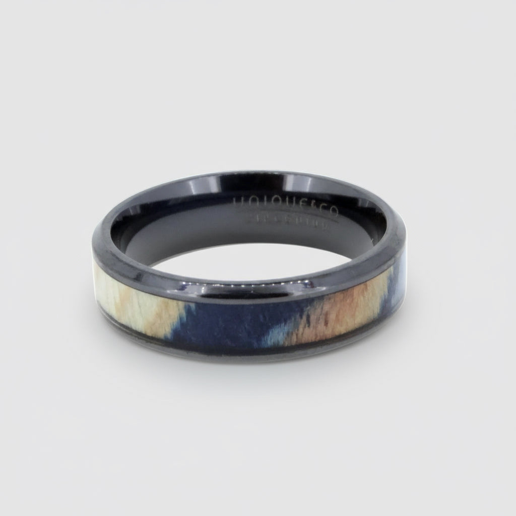 Ring with black and wood-like design on a white background