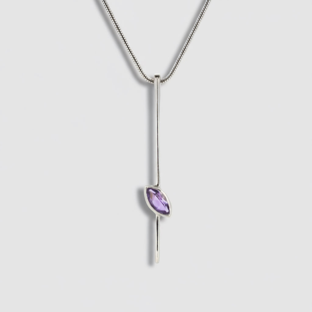 Silver necklace with a purple gemstone pendant on a white background