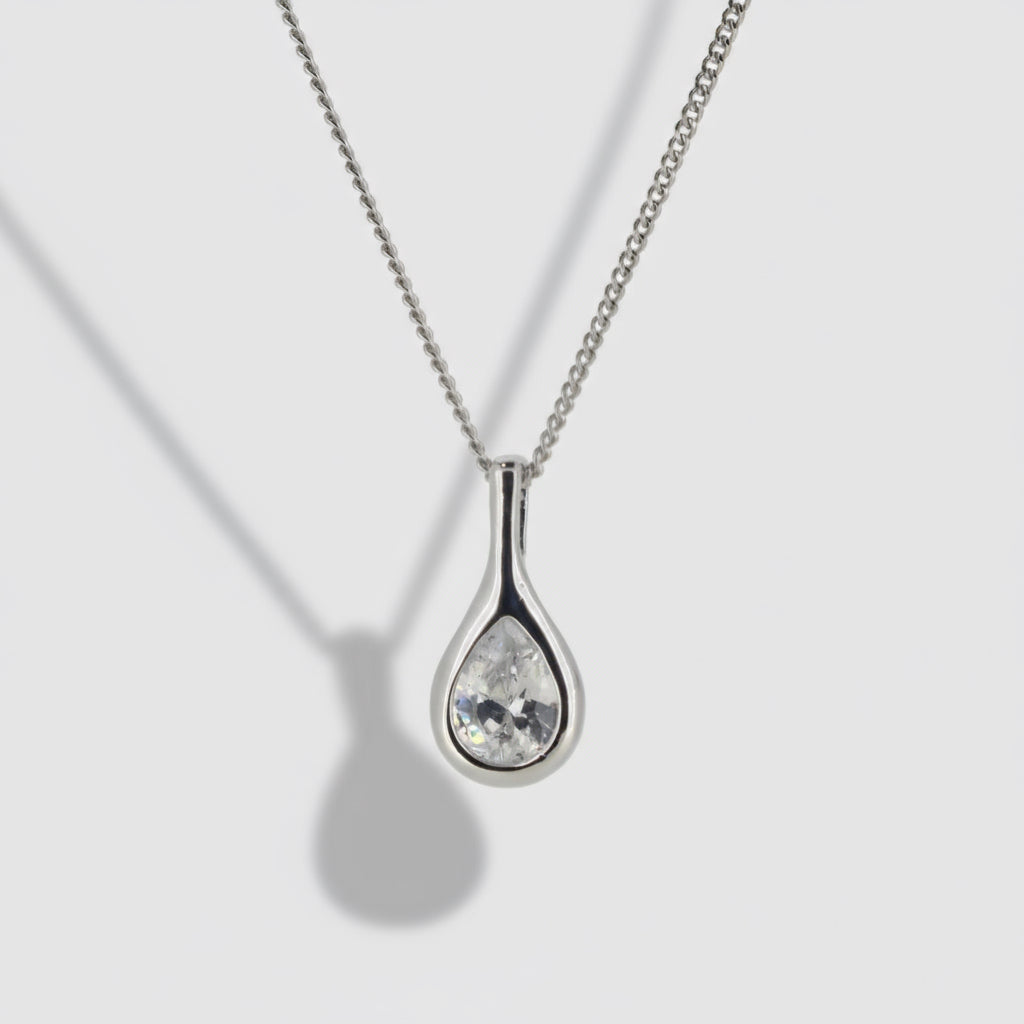 Silver teardrop-shaped pendant necklace on a light gray background