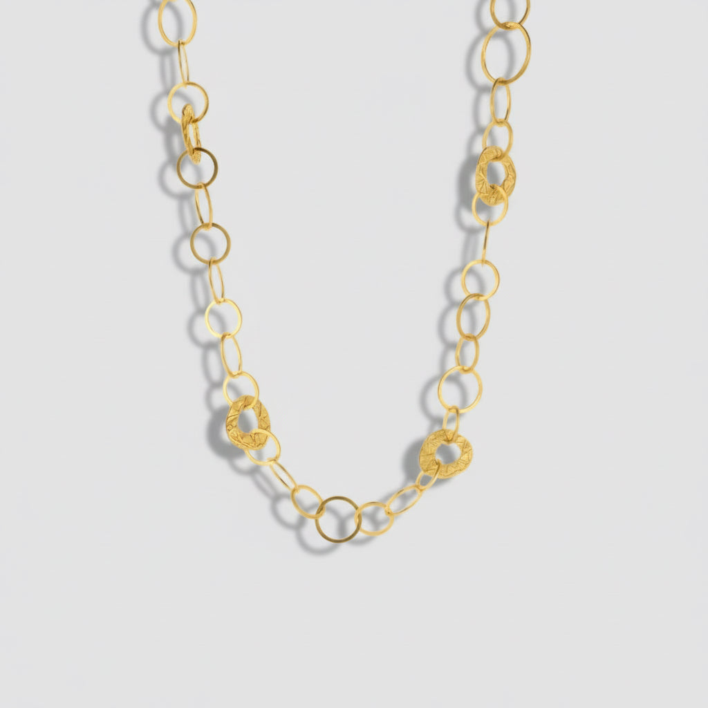 Gold chain necklace on a white background.