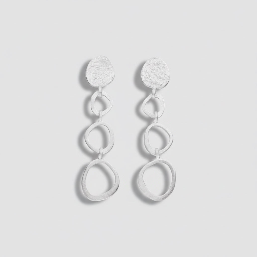 Pair of silver earrings on a white background