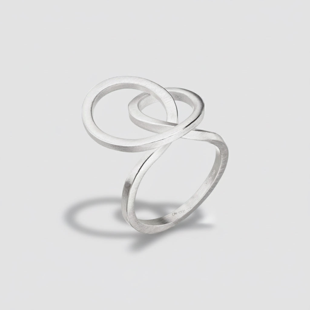 Silver ring with a double loop design on a white background
