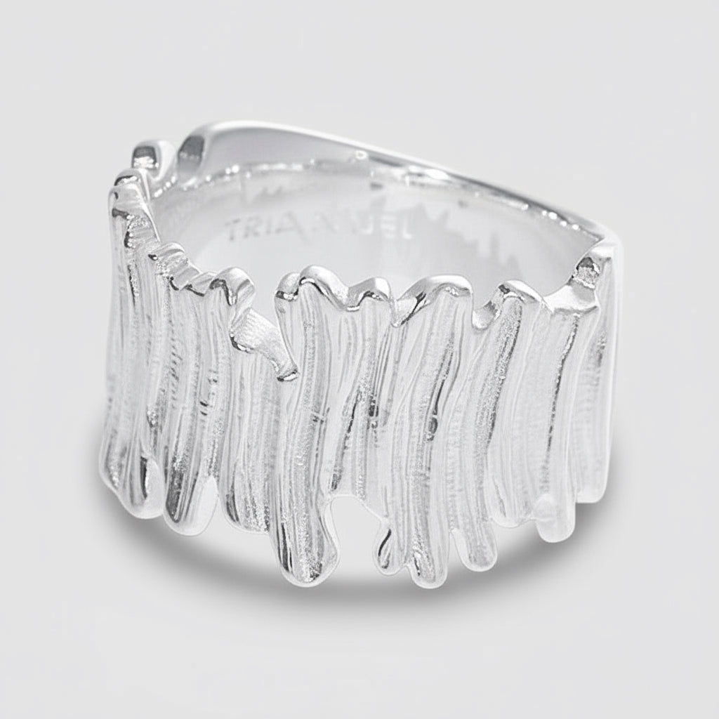 Silver ring with blue gemstones on a white background