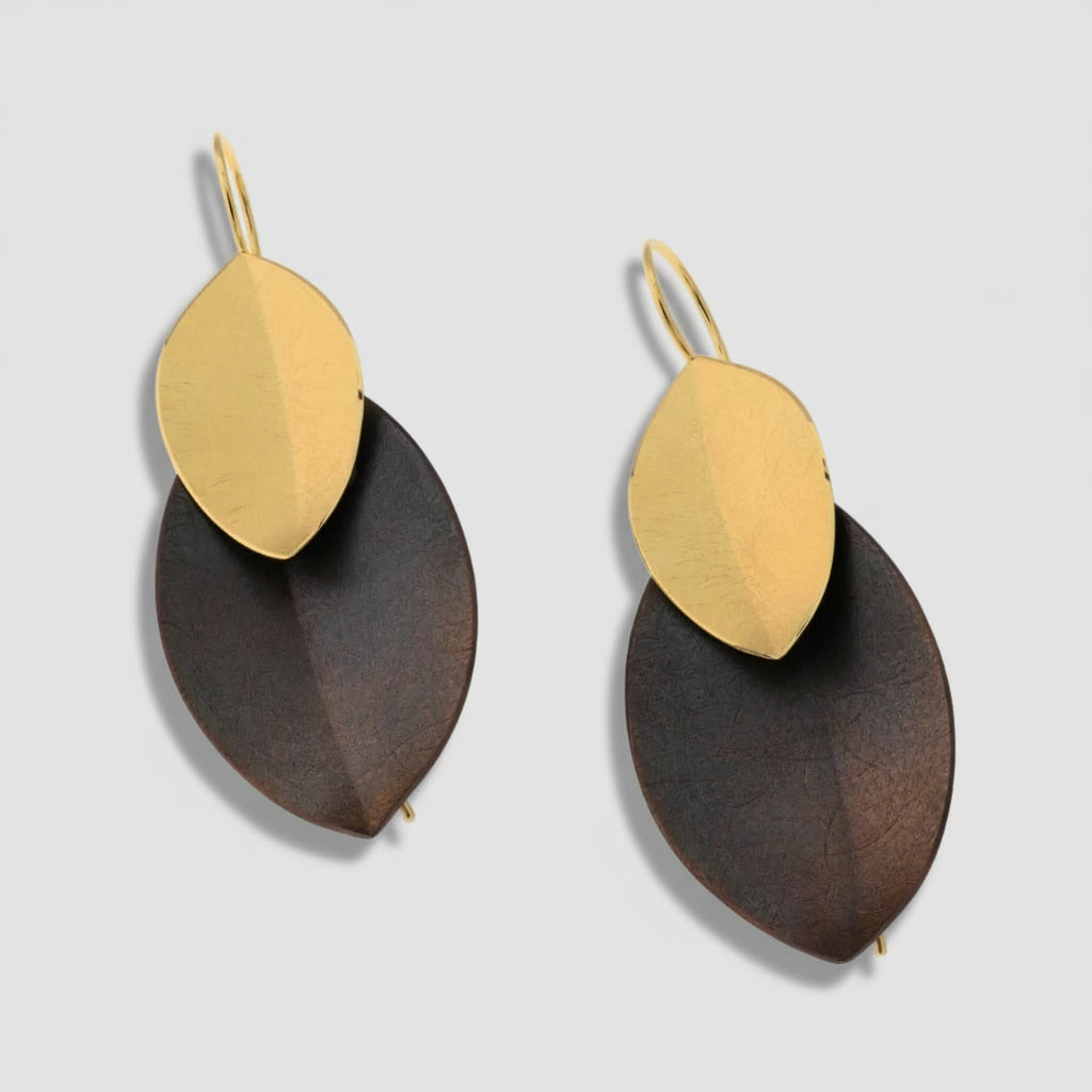 Pair of earrings with gold and brown leaf-shaped pendants on a white background