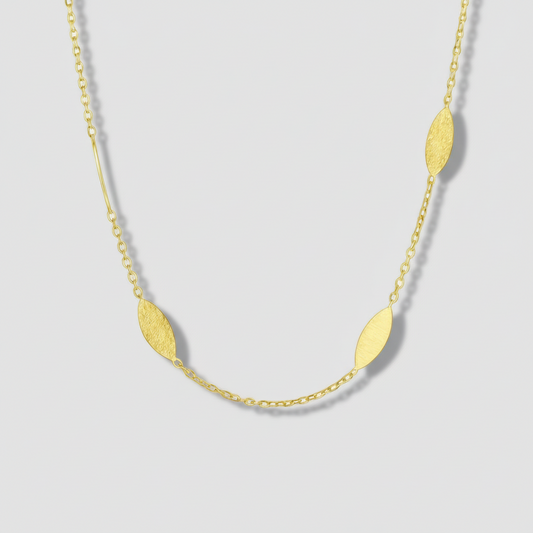 Gold necklace with leaf-shaped pendants on a white background.