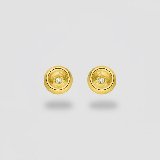 Gold circular earrings with embedded diamonds on a white background