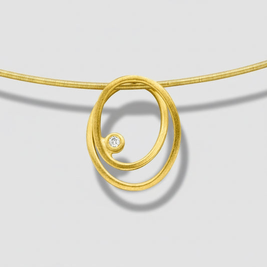 Gold spiral necklace with a diamond on a white background