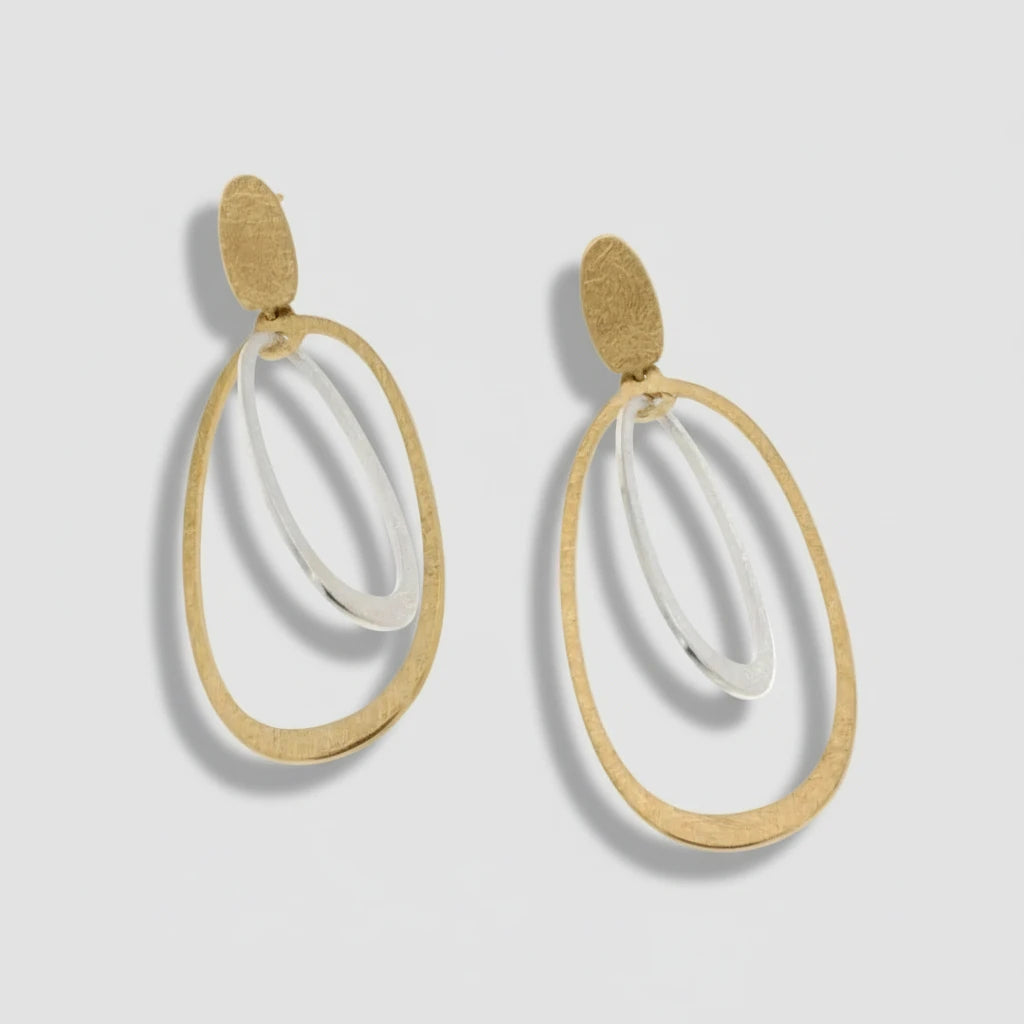 Gold and white hoop earrings on a white background