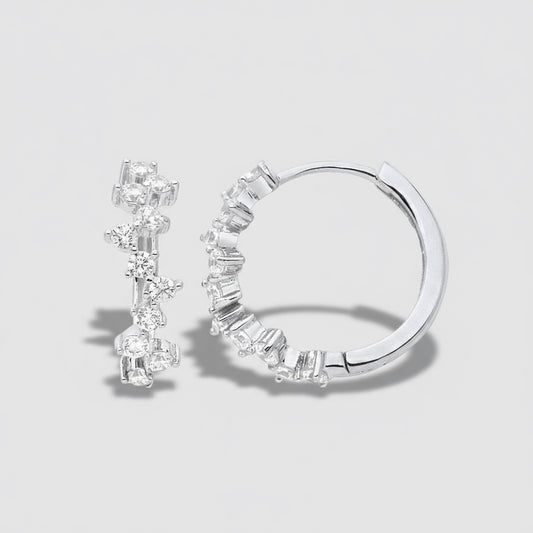 Pair of silver hoop earrings with clear gemstones on a white background