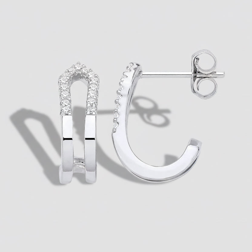 Silver hoop earrings with small diamonds on a white background