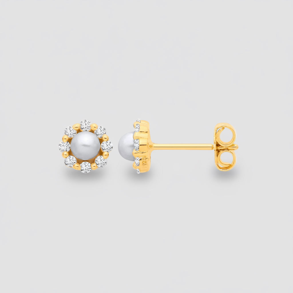 Gold earrings with pearl and diamond accents on a white background