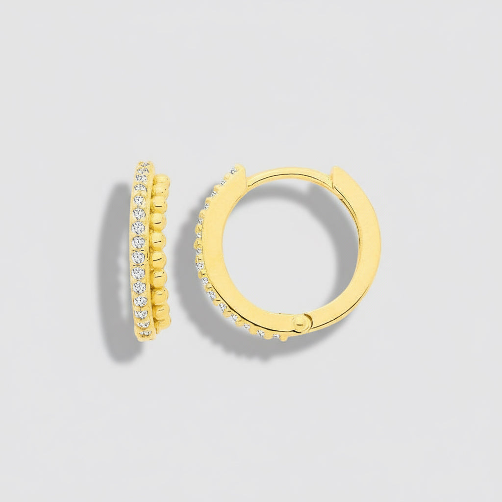 Gold hoop earrings with embedded stones on a white background