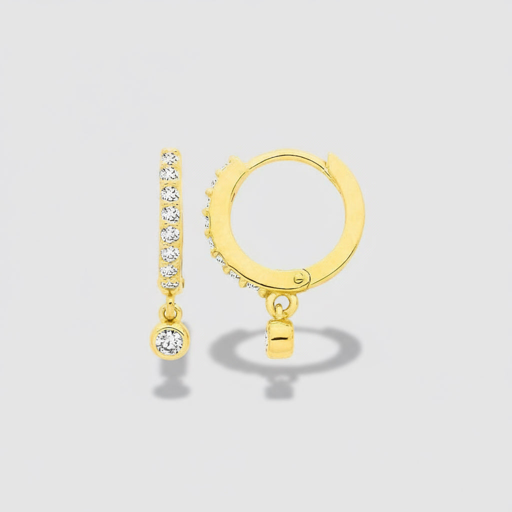 Gold hoop earrings with small round and diamond-studded details on a white background