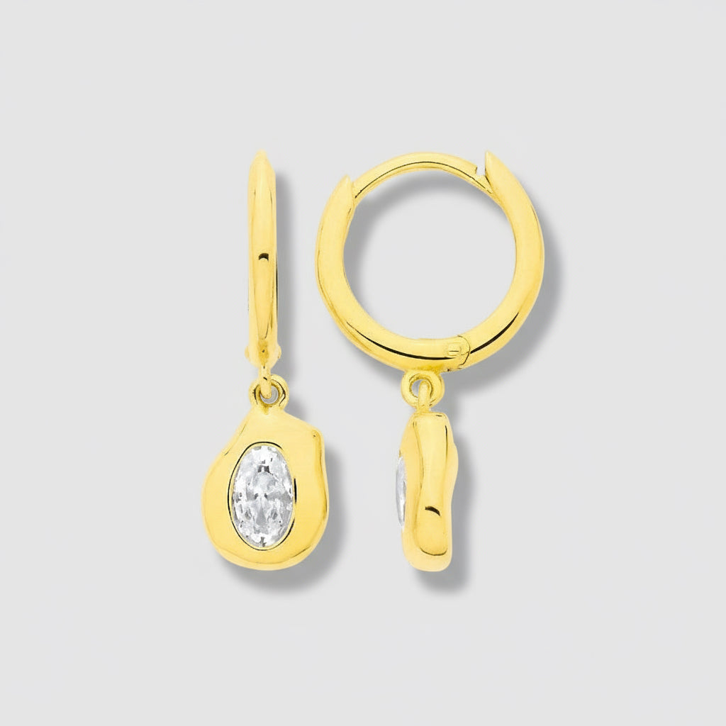 Gold hoop earrings with a small diamond pendant on a white background