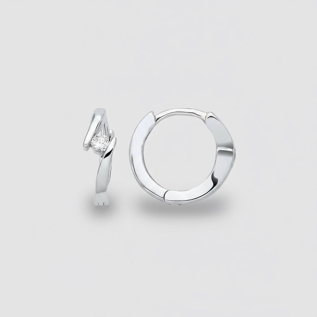 Silver hoop earring with a diamond on a light gray background
