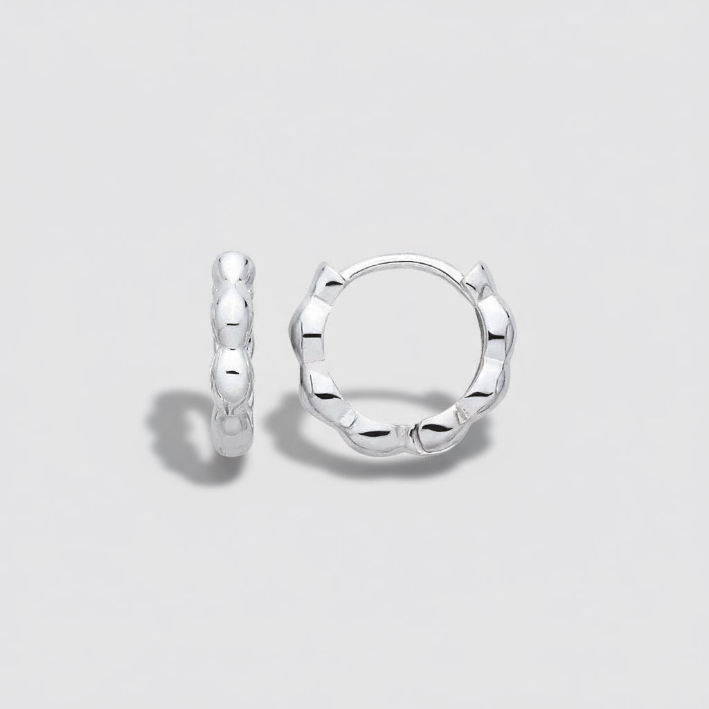 Silver hoop earrings on a light gray background