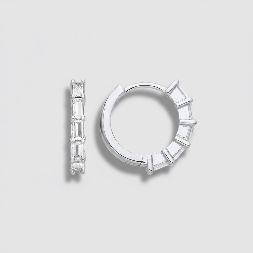 Silver hoop earrings with baguette cut stones on a white background