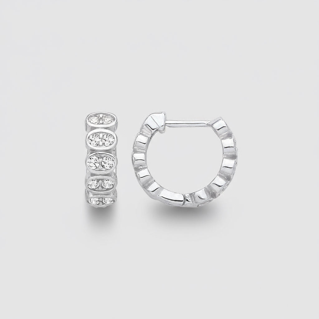 Silver hoop earring with a small round gemstone on a light gray background