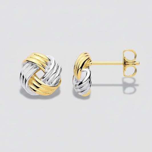 Pair of gold and silver knot earrings on a white background