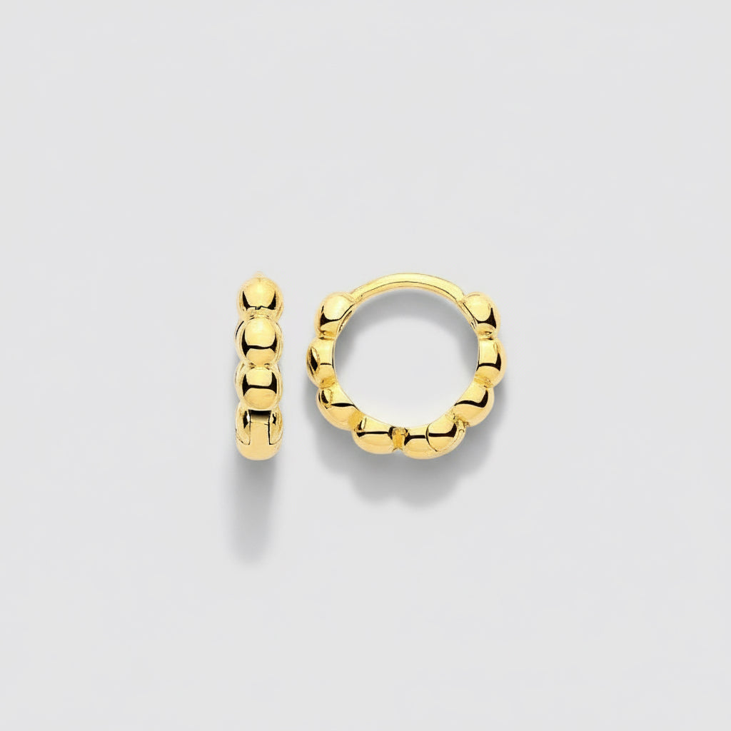 Gold hoop earrings on a white background