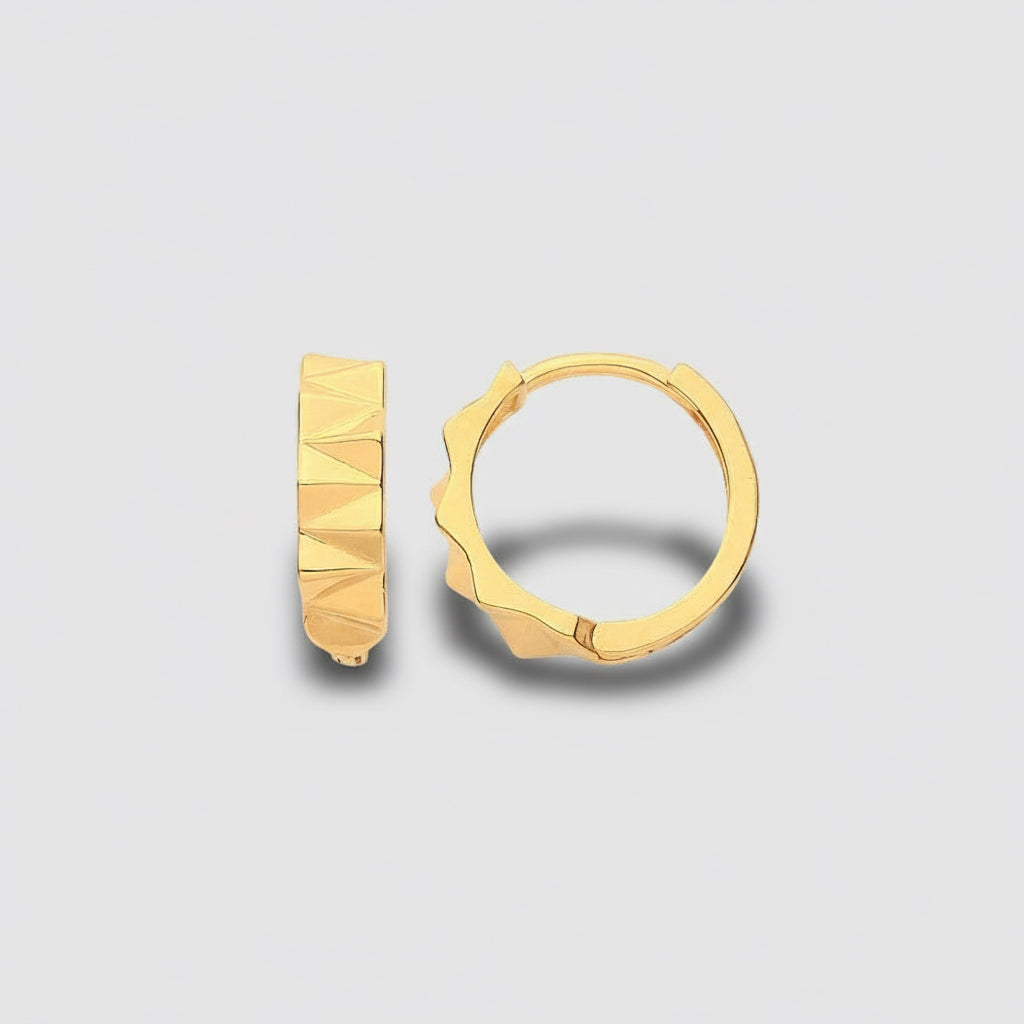 Gold hoop earrings on a light gray background