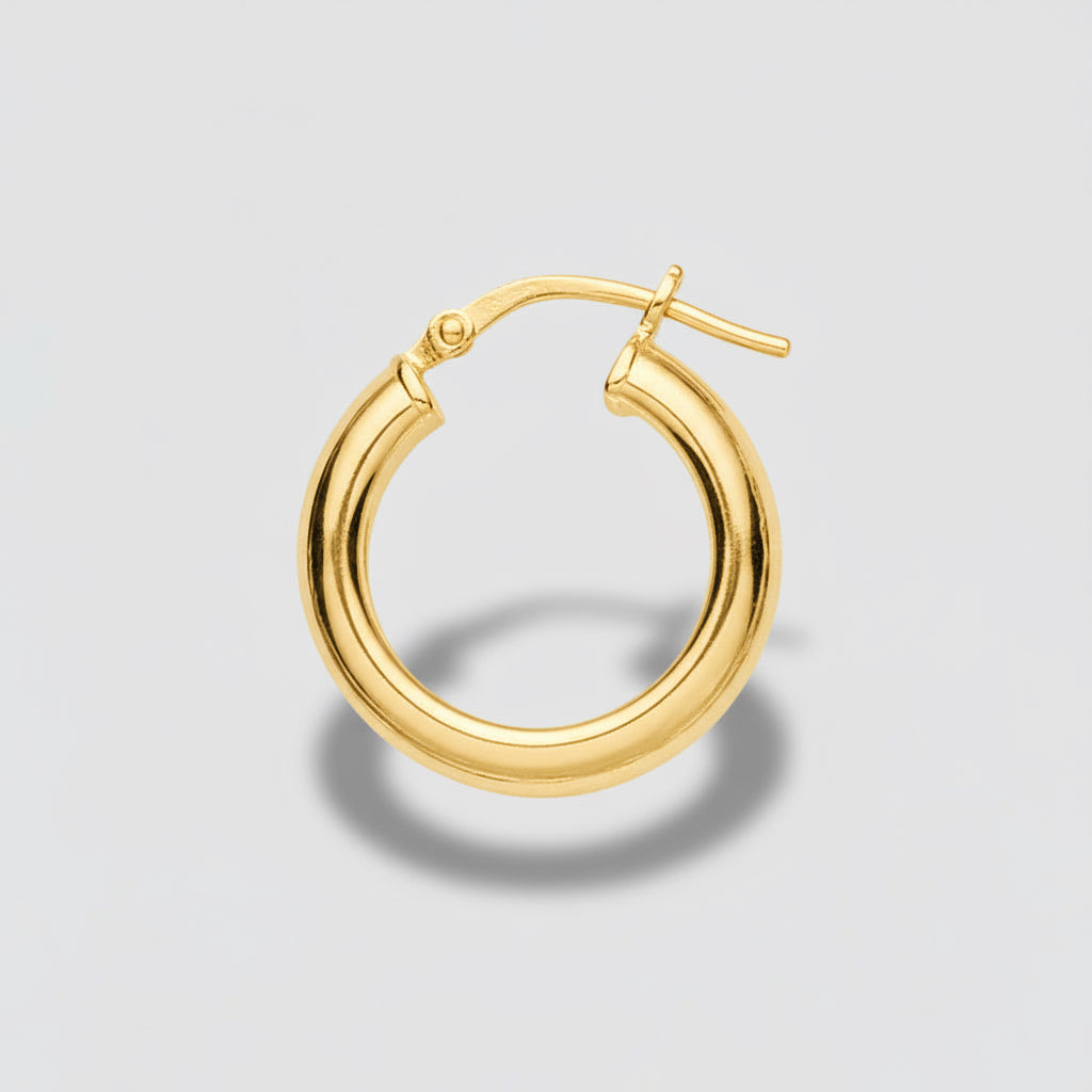 Silver hoop earring on a light gray background