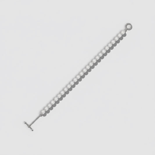 Silver bracelet on a light gray background