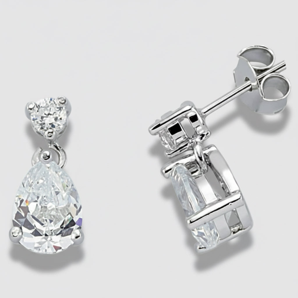 Silver earrings with clear gemstones on a light gray background