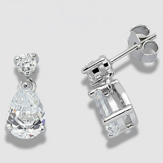 Silver earrings with clear gemstones on a light gray background