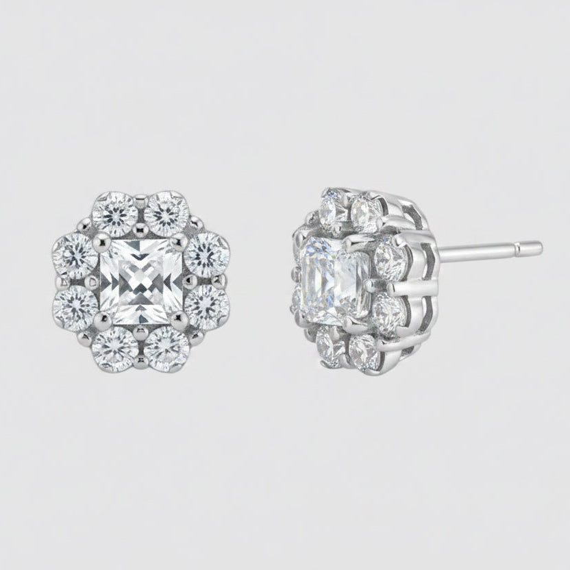 A pair of silver-toned cluster stud earrings with clear gemstones, shown from the front and side angles on a plain white background.