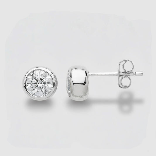 Gold stud earrings with clear gemstones on a light gray background