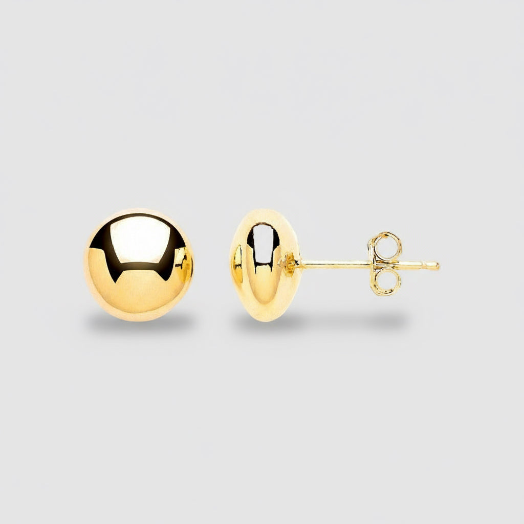 Gold spherical earrings on a white background