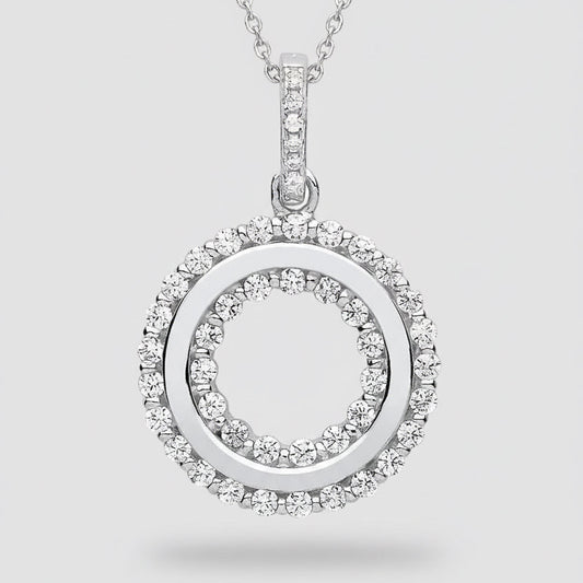 Silver pendant with circular design and embedded stones on a white background
