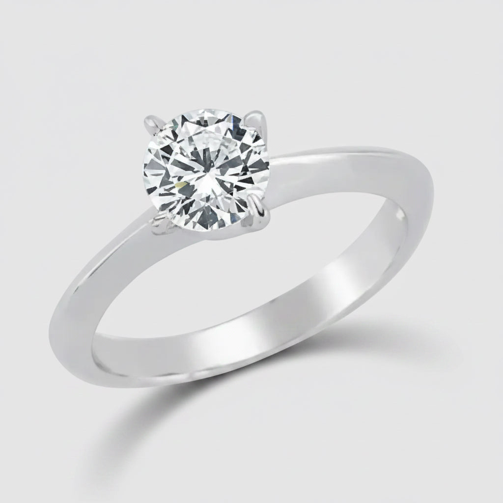 Silver ring with a clear gemstone on a white background