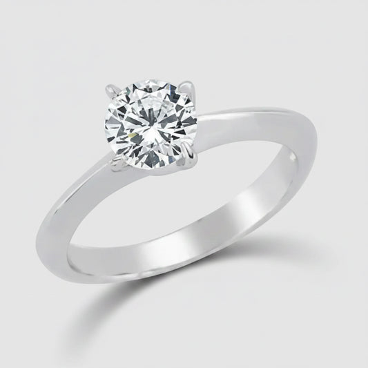 Silver ring with a clear gemstone on a white background