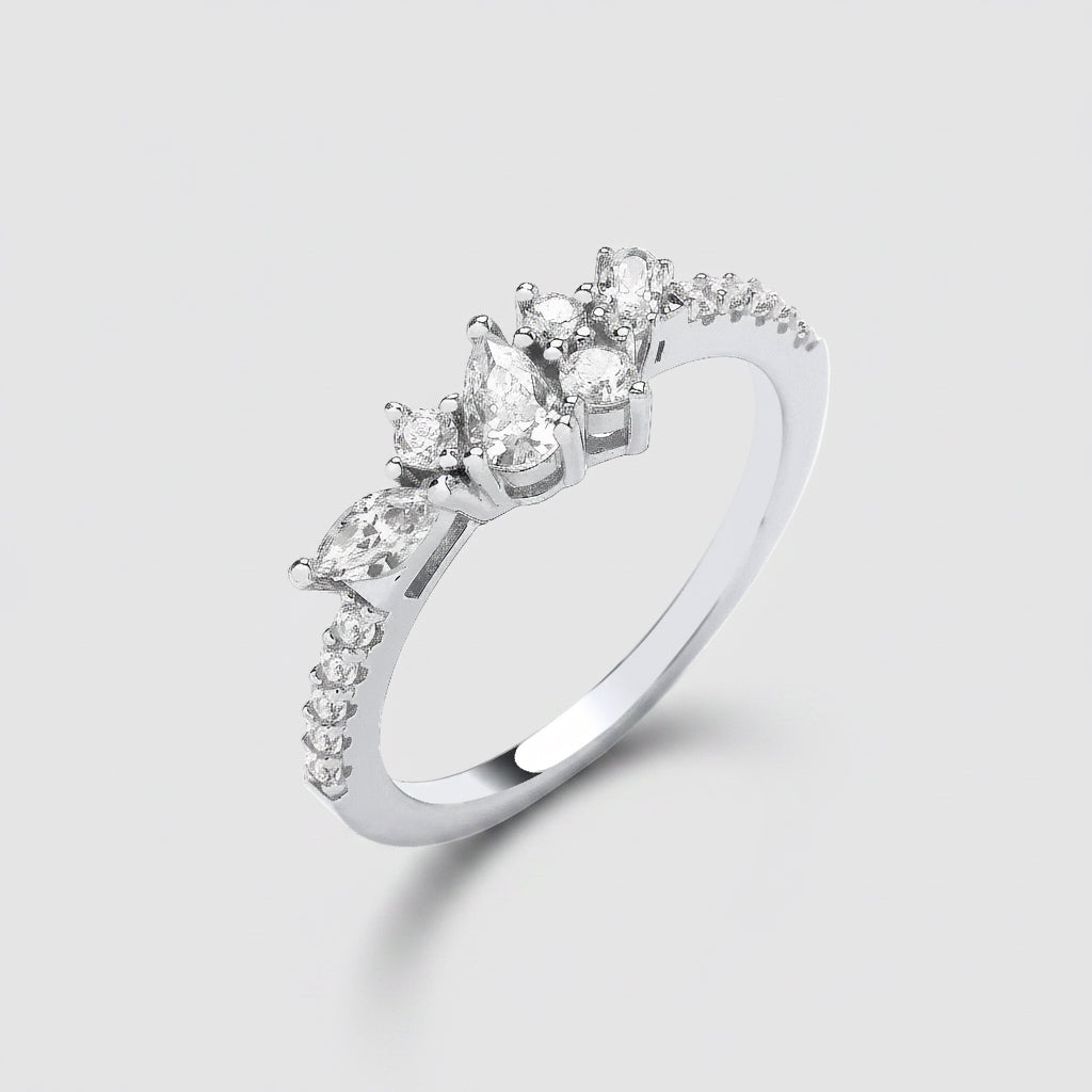 Silver ring with pear-shaped diamonds on a white background